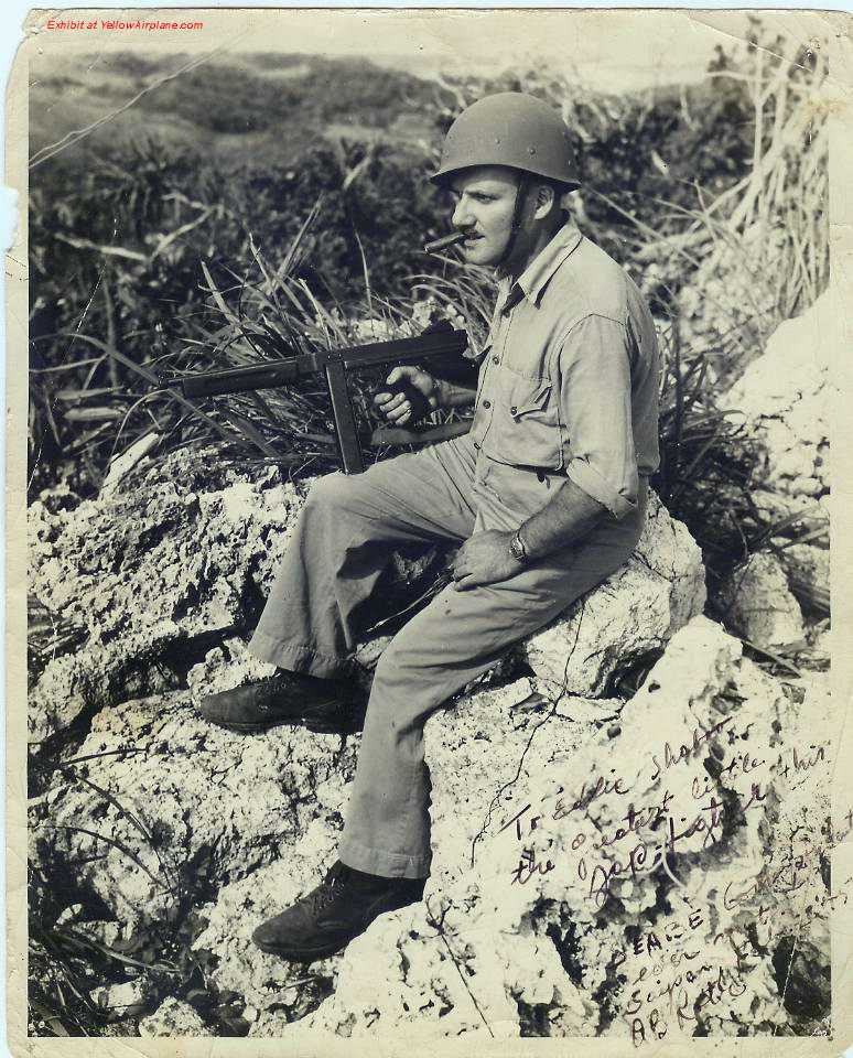 Picture  of Ernie Pyle, War Correspondent, holding a Thompson Machine Gun on the island of Saipan.