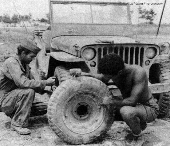 Motorpool workers repairing a Jeep on IeShima in WW2