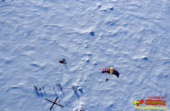 Picture of skydiver parachuting over the geographic north pole ice terrain.