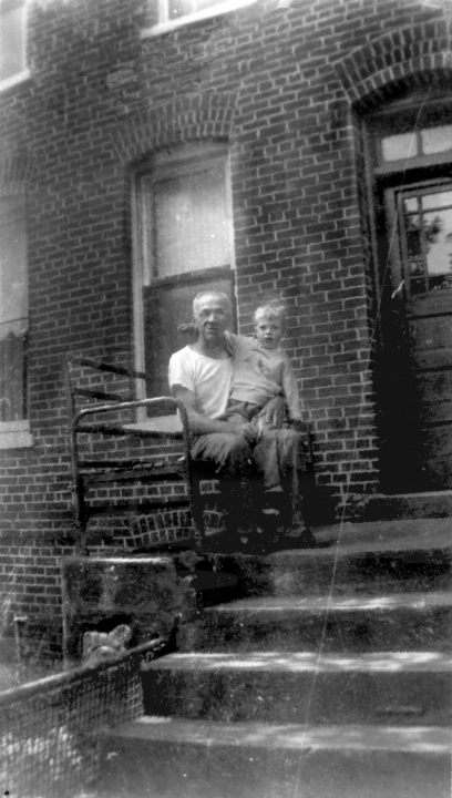 jacob dyrek holding jack dyrek, his grandson, on the porch of pullman housing
