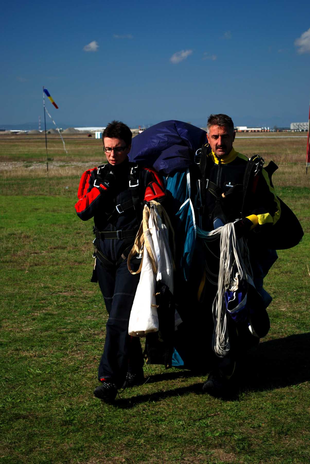 Carrying her parachute, Diana finishes her first jump.