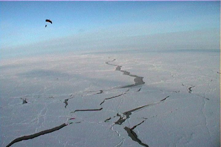 Skydivers photo over open leads on the North Pole.