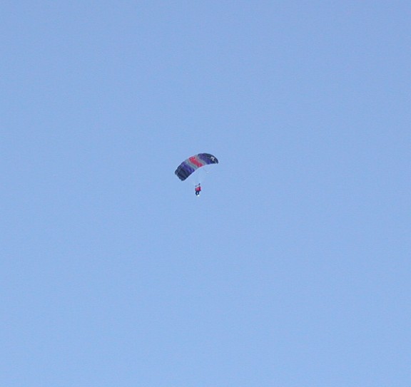 The first skydiver has his parachute open on the North Pole.