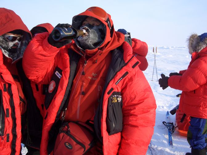 Passing the Champagne bottle after reaching the North Pole
