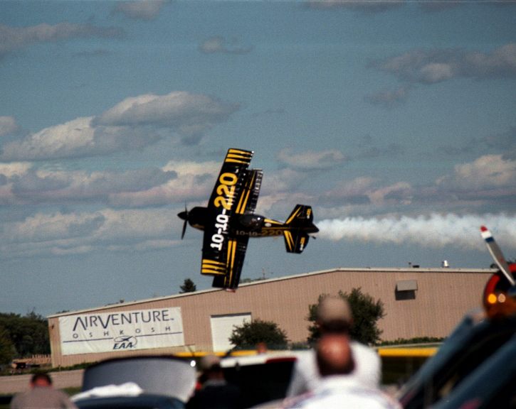 Sean Tucker flys at a low level knife edge at the Oshkosh air show