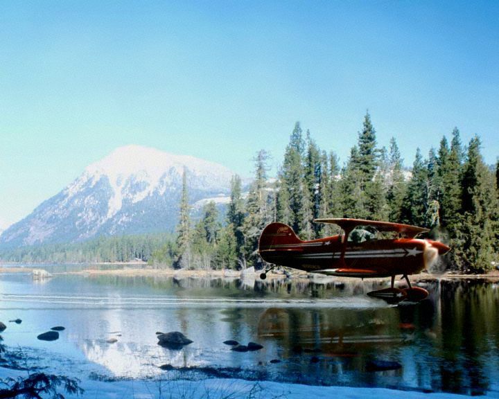 Photo of a Pitts Airplane Skimming the Water.