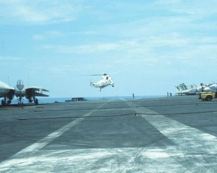 an sikorsky H-3 sea king helicopter lands on the deck of the uss kitty hawk
