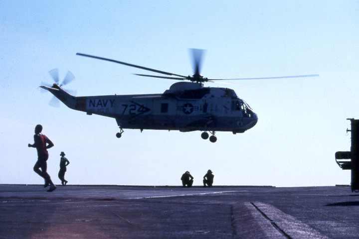 an h3 sea king helicopter lands on the flight deck of the uss kitty hawk navy aircraft carrier
