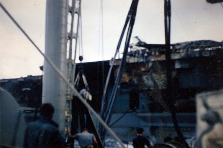 A Second photo of the British Navy Tidesurge (A98), photographs the USS Forrestal Fire Damage in 1967
