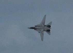 An f14 spreads its wings over the uss kitty hawk