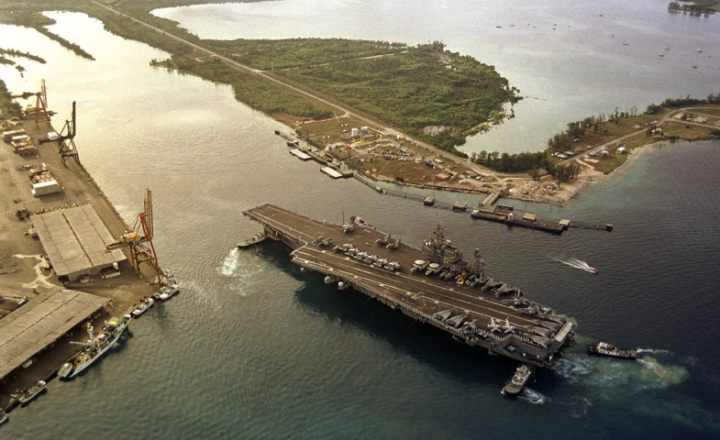 an aerial view of the uss kitty hawk in the guam harbor